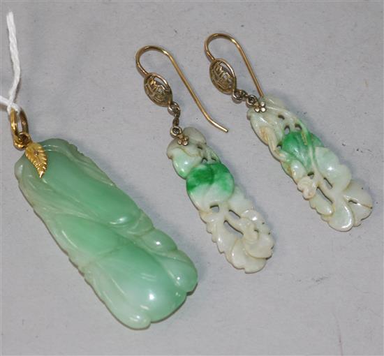 A carved jade pendant and pair of carved jade earrings.